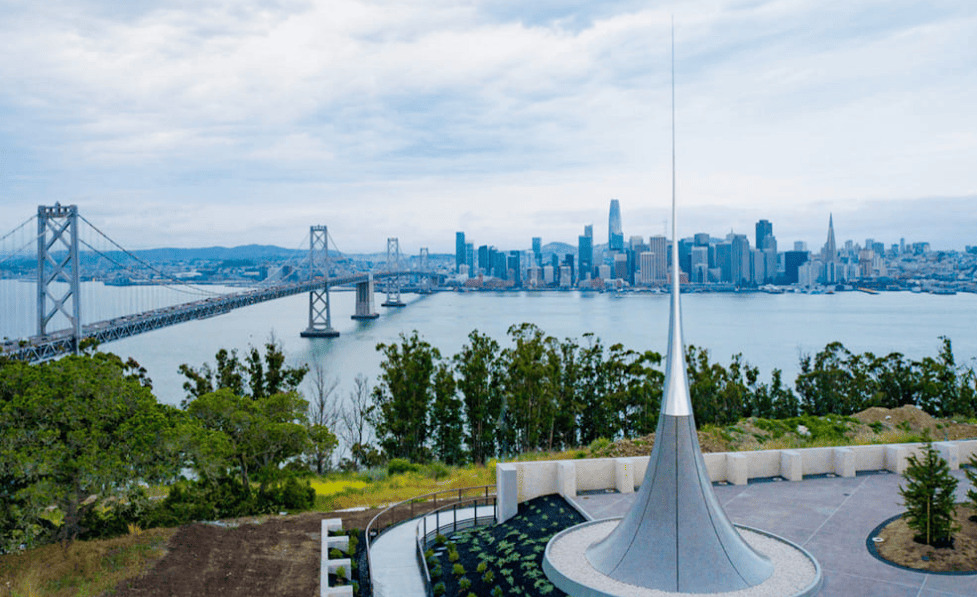 サンフランシスコのベイブリッジとダウンタウンを背景に立つ作品