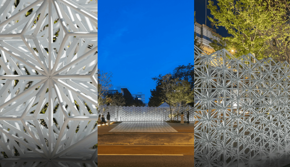 夕暮れ時に照明が浮かび上がらせる繊細な門扉と柵